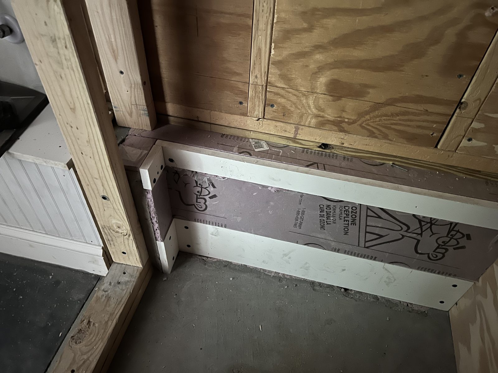 Framed shower bench with insulation installed between the studs